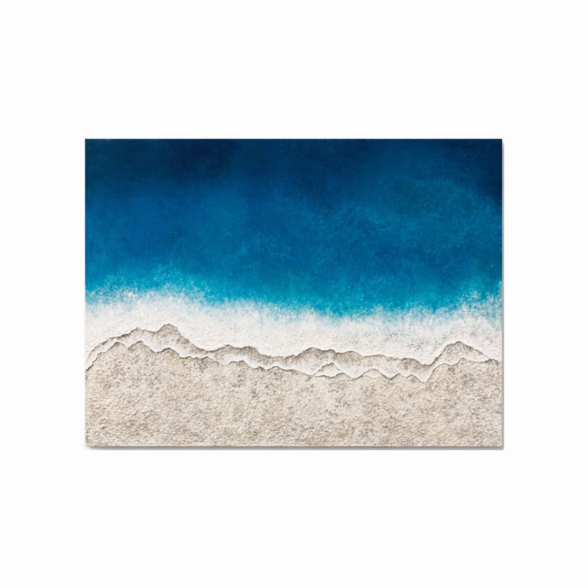 Textured coastal wall art showing blue ocean waves meeting sandy beach in horizontal canvas
