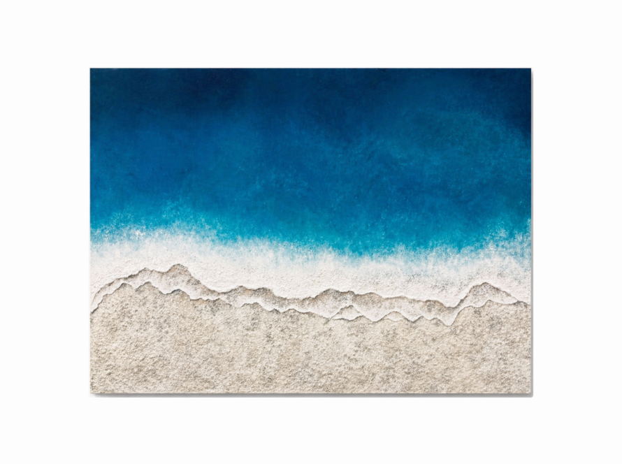 Textured coastal wall art showing blue ocean waves meeting sandy beach in horizontal canvas
