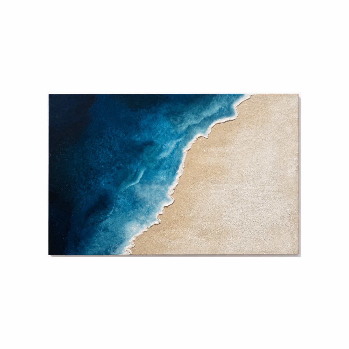 Modern coastal wall art with deep blue ocean and sandy beach in diagonal composition - coastal wall art